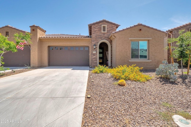 16935 W Sheridan St, Goodyear, AZ 85395 - mediterranean / spanish house with a tile roof, concrete driveway, an attached garage, and stucco siding