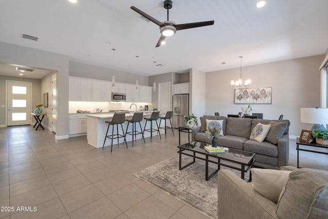16935 W Sheridan St, Goodyear, AZ 85395 - living room featuring a chandelier, light tile patterned flooring, ceiling fan, and recessed lighting