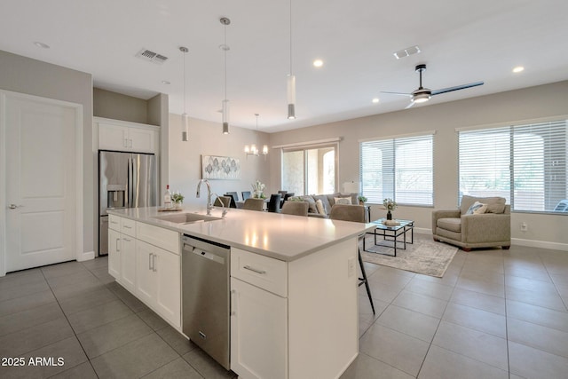 16935 W Sheridan St, Goodyear, AZ 85395 - kitchen with a sink, stainless steel appliances, open floor plan, light tile patterned floors, and recessed lighting