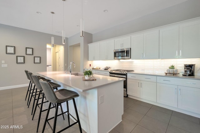 16935 W Sheridan St, Goodyear, AZ 85395 - kitchen with stainless steel appliances, a sink, dark tile patterned flooring, and tasteful backsplash