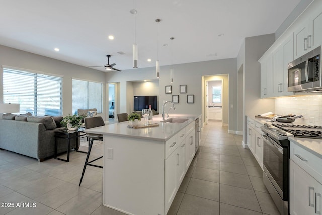16935 W Sheridan St, Goodyear, AZ 85395 - kitchen featuring stainless steel appliances, open floor plan, a sink, healthy amount of natural light, and recessed lighting