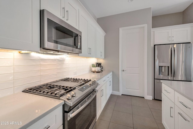 16935 W Sheridan St, Goodyear, AZ 85395 - kitchen with appliances with stainless steel finishes, tasteful backsplash, light countertops, and white cabinets