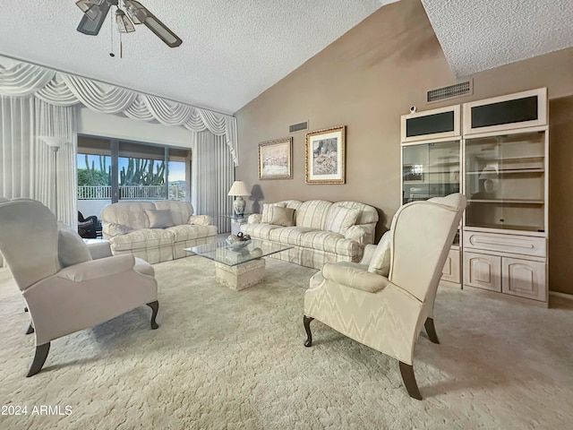 living room with ceiling fan, lofted ceiling, a textured ceiling, and light carpet