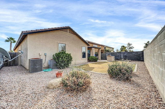 back of property with cooling unit and a patio area