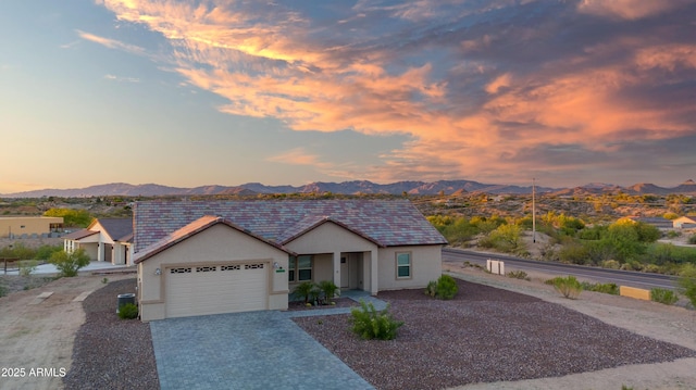 2010 Paseo Montana, Wickenburg, AZ 85390 - view of front of home with an attached garage, a mountain view, decorative driveway, stucco siding, and a tiled roof