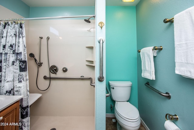 bathroom featuring vanity, toilet, and curtained shower