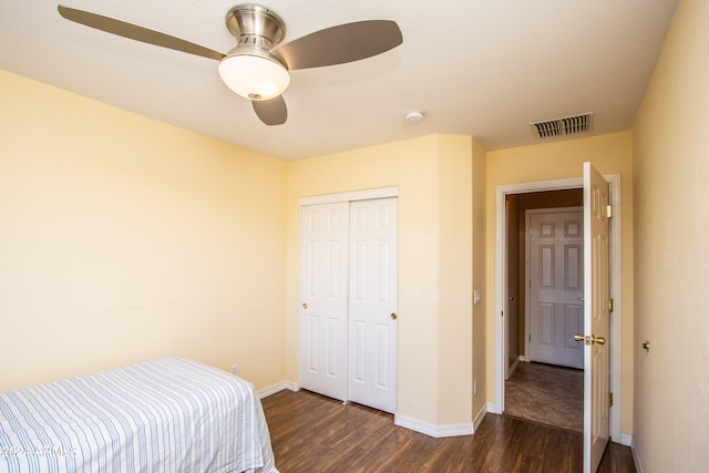 bedroom with a closet, ceiling fan, and dark hardwood / wood-style floors