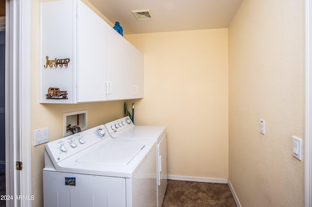 washroom featuring washer and clothes dryer and cabinets