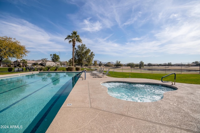 view of swimming pool with a patio area and a yard