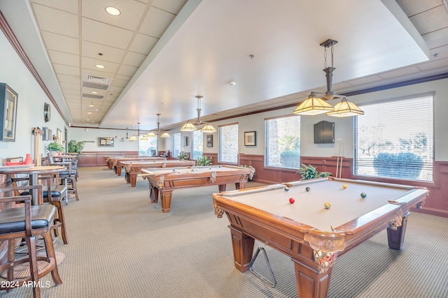 rec room with a paneled ceiling, light carpet, wood walls, and pool table