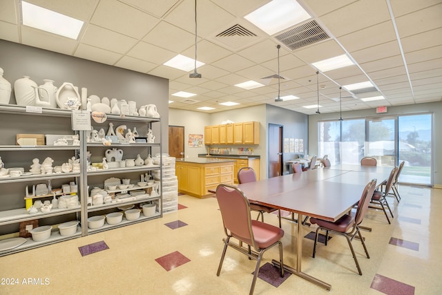 dining area featuring a drop ceiling