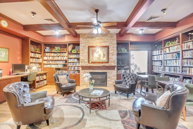 sitting room featuring built in shelves, coffered ceiling, and beam ceiling