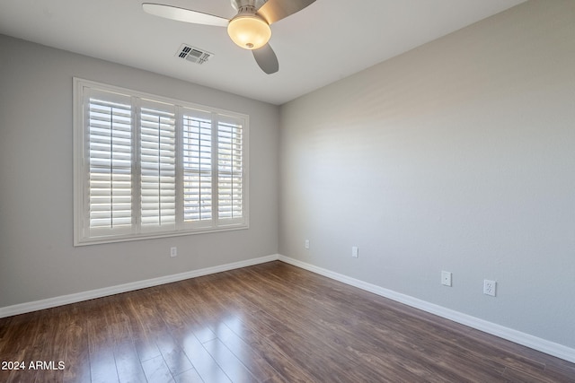 unfurnished room with ceiling fan and dark wood-type flooring