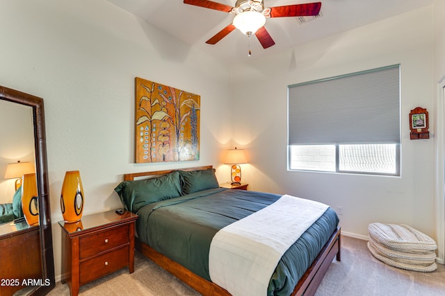 bedroom with ceiling fan and light carpet