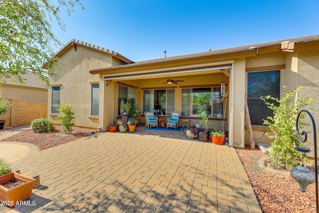 back of property with a patio and ceiling fan