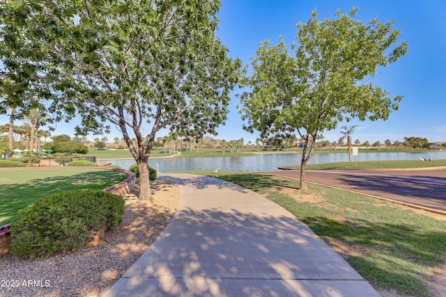 exterior space featuring a water view and a lawn