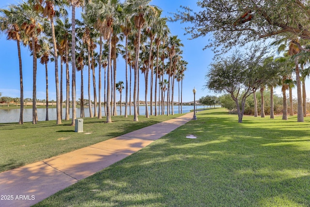 view of home's community featuring a water view and a yard