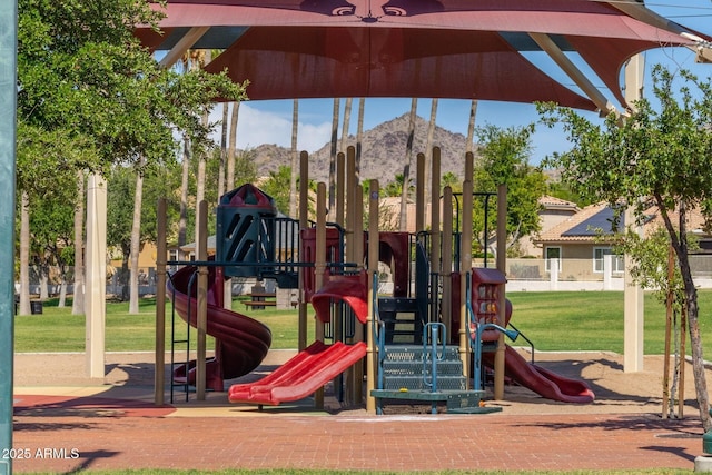 view of playground featuring a mountain view and a lawn