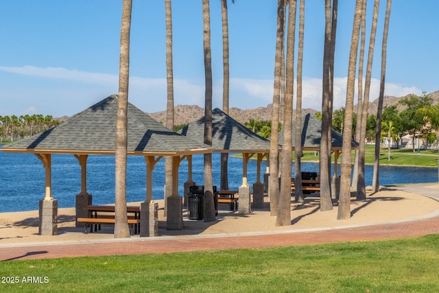 surrounding community with a gazebo and a water view