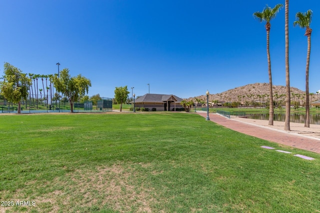 view of home's community with a yard and a water and mountain view