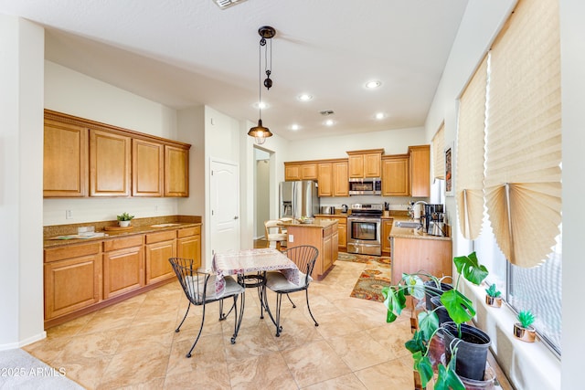 kitchen with pendant lighting, sink, stainless steel appliances, a center island, and light tile patterned flooring