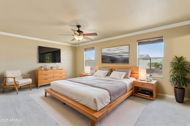 bedroom featuring light colored carpet, crown molding, baseboards, and ceiling fan