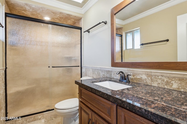 full bathroom featuring vanity, ornamental molding, a shower stall, and toilet