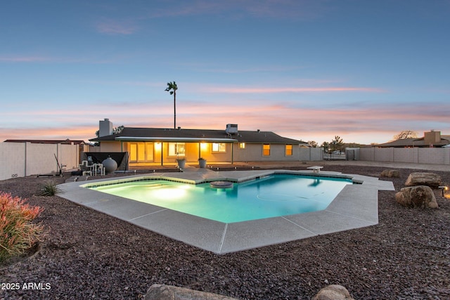 view of pool featuring a fenced in pool, a fenced backyard, a patio, and a diving board