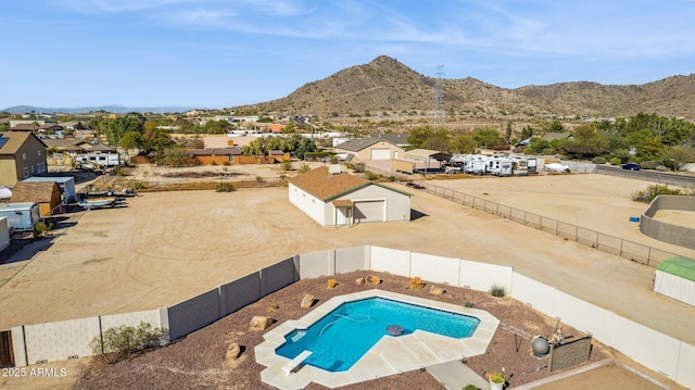 view of pool with a fenced backyard, a residential view, and a mountain view