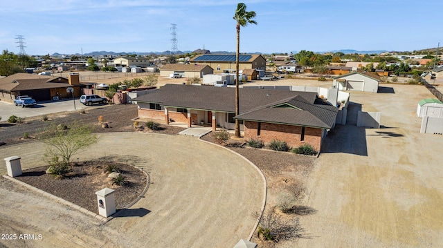 view of front facade featuring driveway, a residential view, and fence