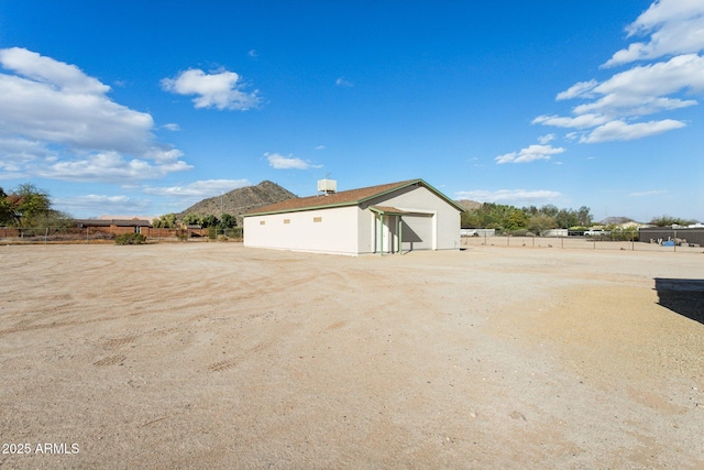 detached garage with fence and a mountain view