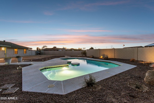 view of swimming pool featuring a diving board, a patio, a fenced backyard, and a fenced in pool