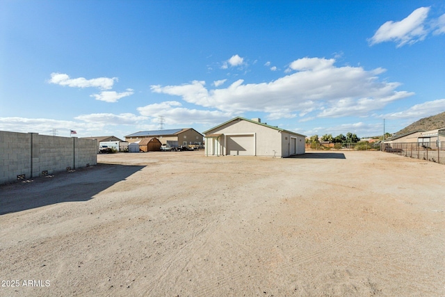 view of outbuilding with fence and an outbuilding