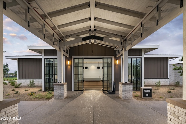 view of exterior entry with board and batten siding