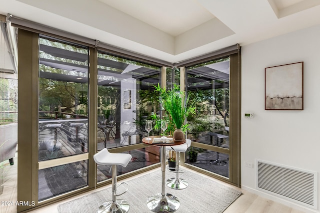 sunroom featuring a tray ceiling