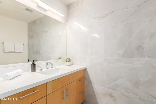 bathroom with tile walls and vanity