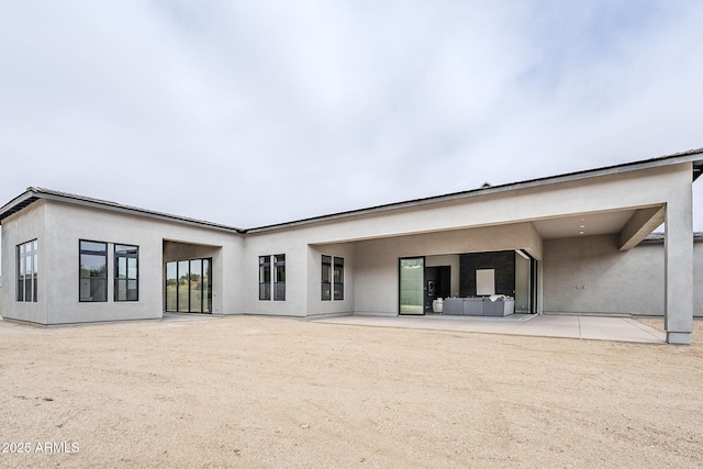 rear view of house with an outdoor hangout area and a patio