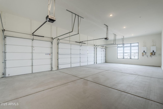 garage with a garage door opener, electric panel, and water heater