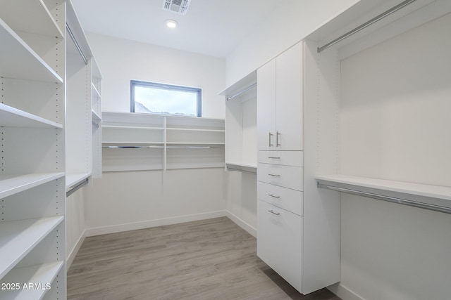 walk in closet featuring light hardwood / wood-style flooring