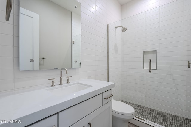 bathroom featuring vanity, a shower with shower door, and toilet