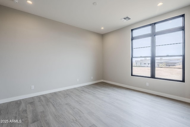 empty room with light hardwood / wood-style flooring