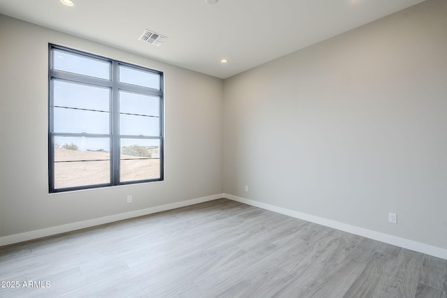 unfurnished room with light hardwood / wood-style floors