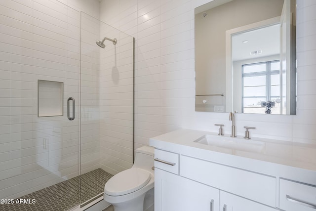 bathroom featuring walk in shower, vanity, and toilet