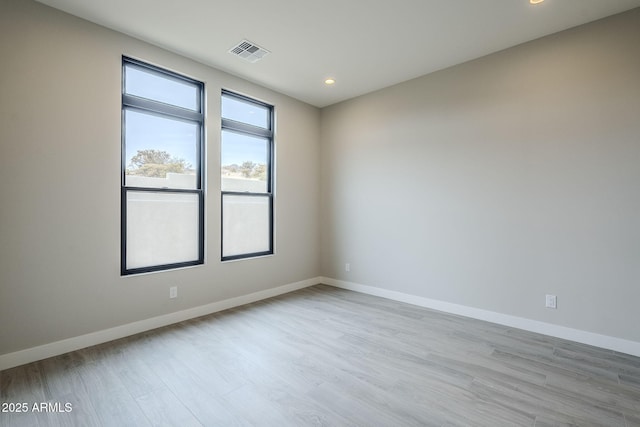 unfurnished room with light wood-type flooring