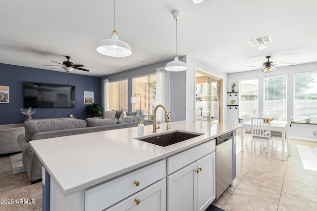 kitchen with white cabinetry, dishwasher, sink, pendant lighting, and a center island with sink