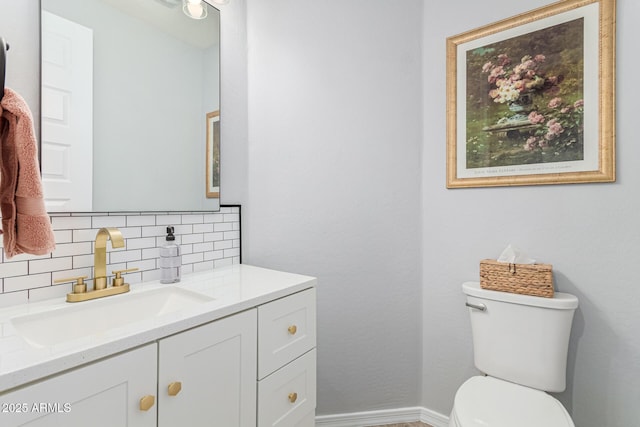 bathroom featuring decorative backsplash, toilet, and vanity