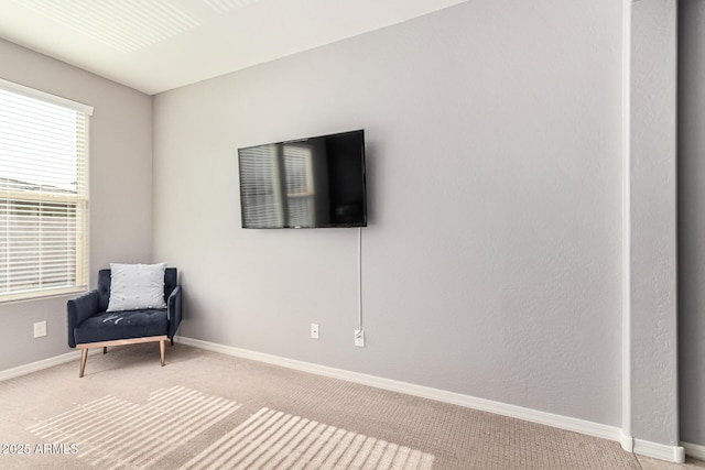 sitting room featuring light colored carpet