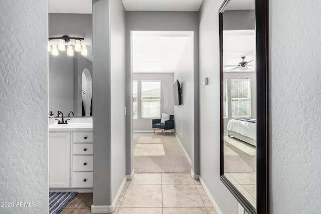 bathroom with tile patterned flooring, vanity, ceiling fan, and a wealth of natural light