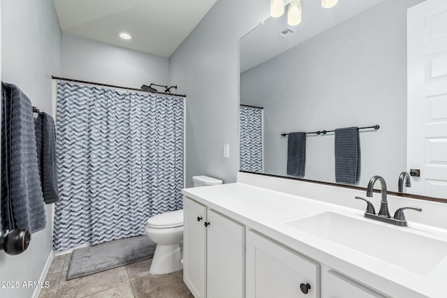 bathroom with tile patterned flooring, vanity, and toilet