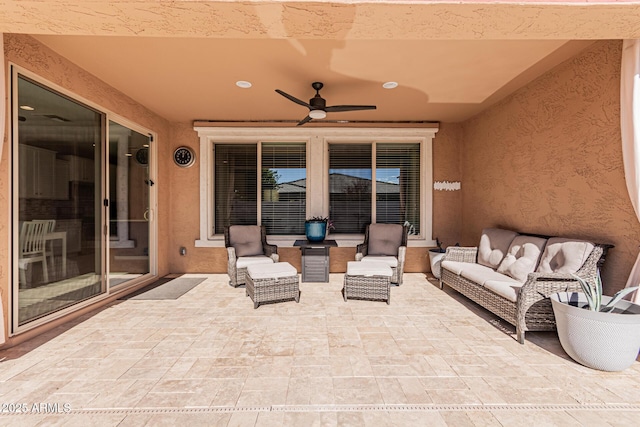 view of patio with an outdoor living space and ceiling fan